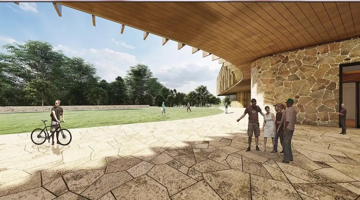 Rendering of a curved timber-canopied campus building with a stone plaza and cyclist in Bentonville, Arkansas