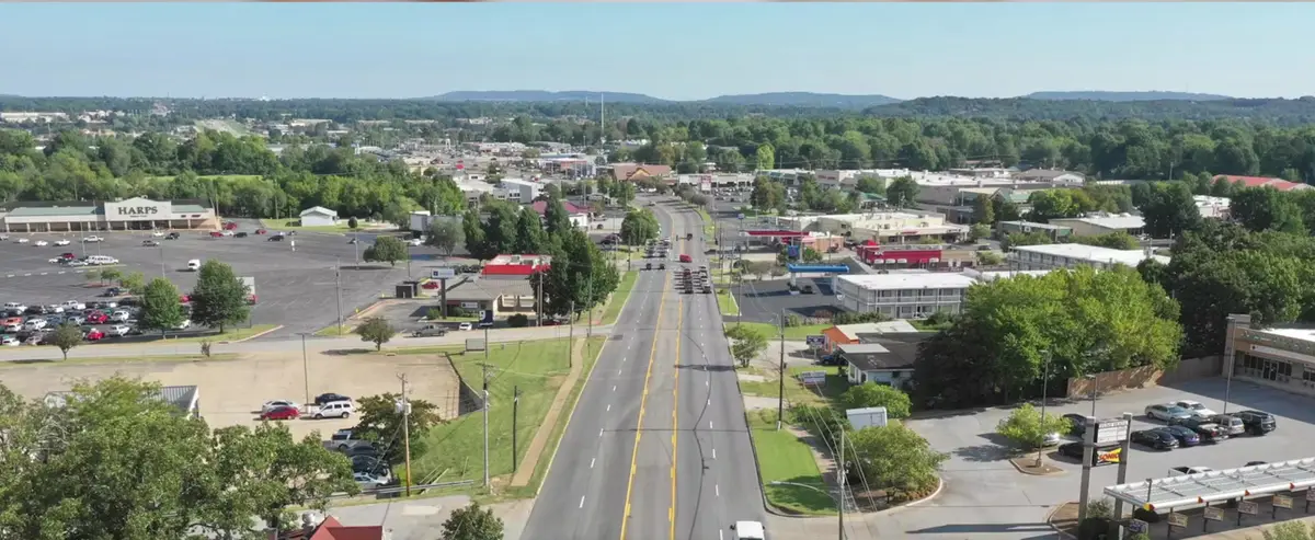 Aerial view of the College Avenue Highway 71B commercial corridor in Fayetteville, Arkansas, showing its five-lane cross-section and strip retail