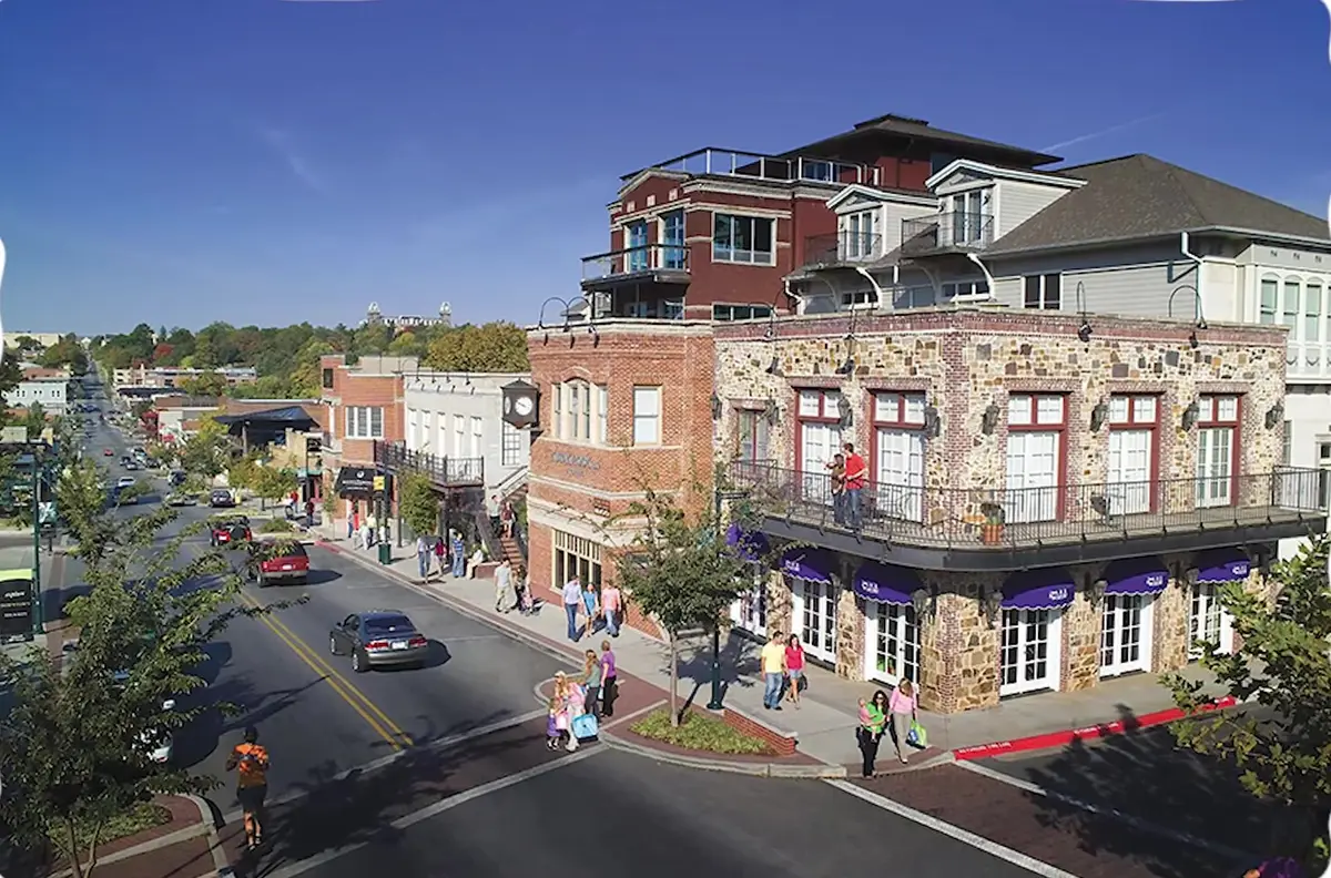 Elevated view of a brick and stone corner building and busy shopping street in downtown Fayetteville, Arkansas