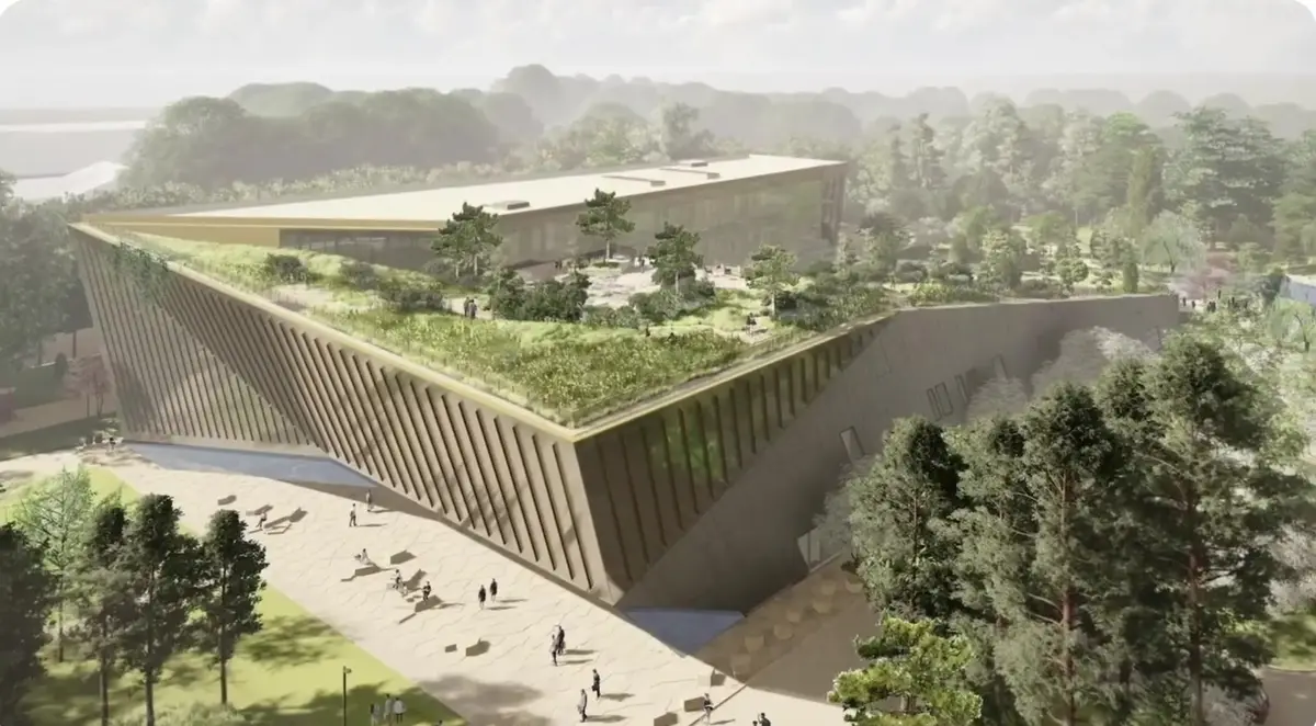 Rendering of an angular institutional building with a planted green roof set into a wooded Northwest Arkansas campus