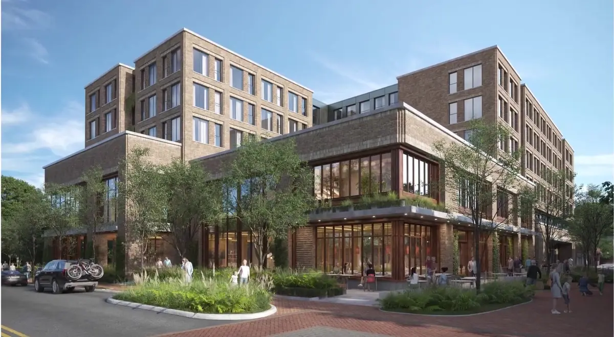 Rendering of a brick mixed-use building with ground-floor retail and landscaped sidewalks in Northwest Arkansas