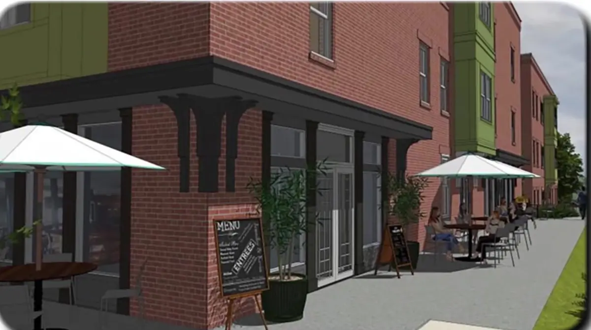Rendering of a brick mixed-use building with a corner cafe and sidewalk patio seating in Northwest Arkansas