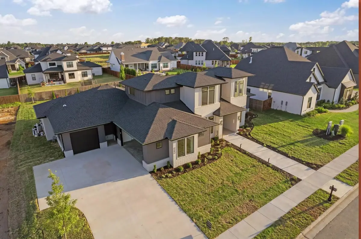 Aerial view of newly built homes and fresh sod in a growing Northwest Arkansas subdivision