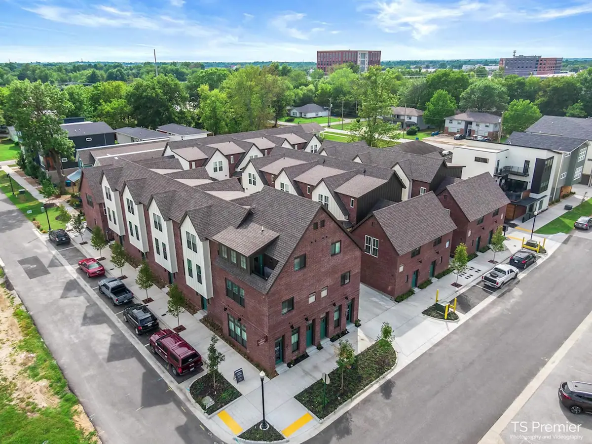 Aerial view of a row of new brick townhomes, the for-sale missing-middle housing type Northwest Arkansas has been short on