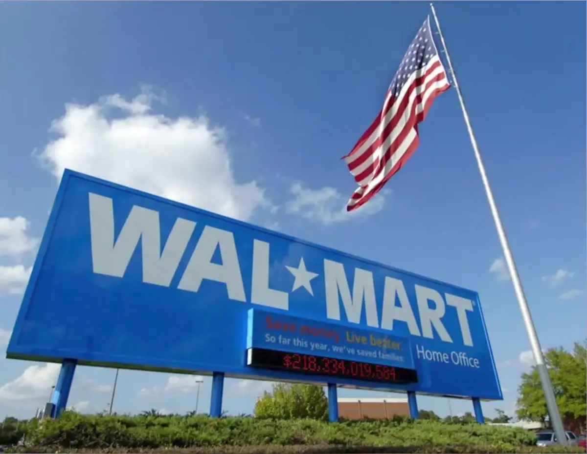 The Walmart Home Office sign and American flag under a blue sky in Bentonville, Arkansas